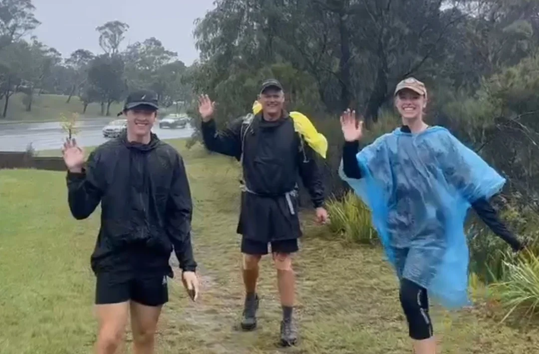 A group of people in rain ponchos can be seen braving the elements during the 30-Hour Enduro Walk.