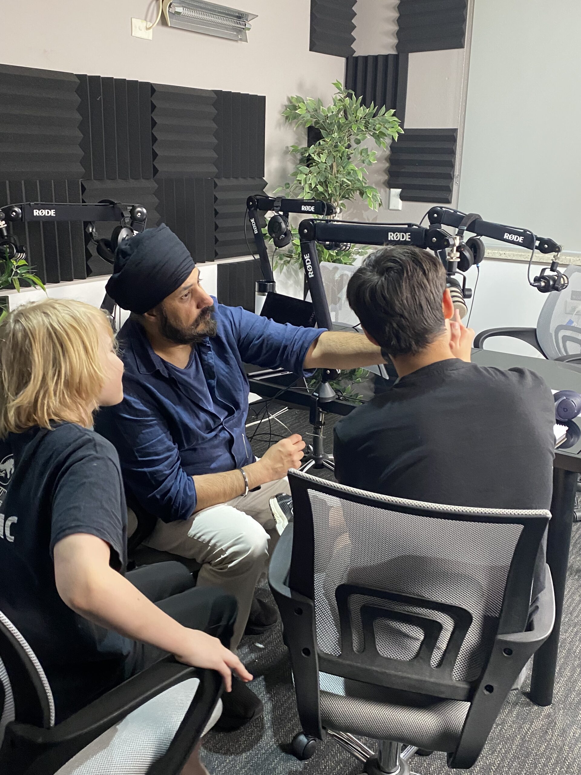 Young people recording in the podcast studio with RODE microphones